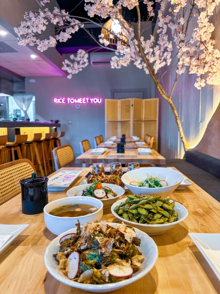 Small plates on a table beneath the cherry blossom tree at Nori Nori, Seminole Heights Tampa