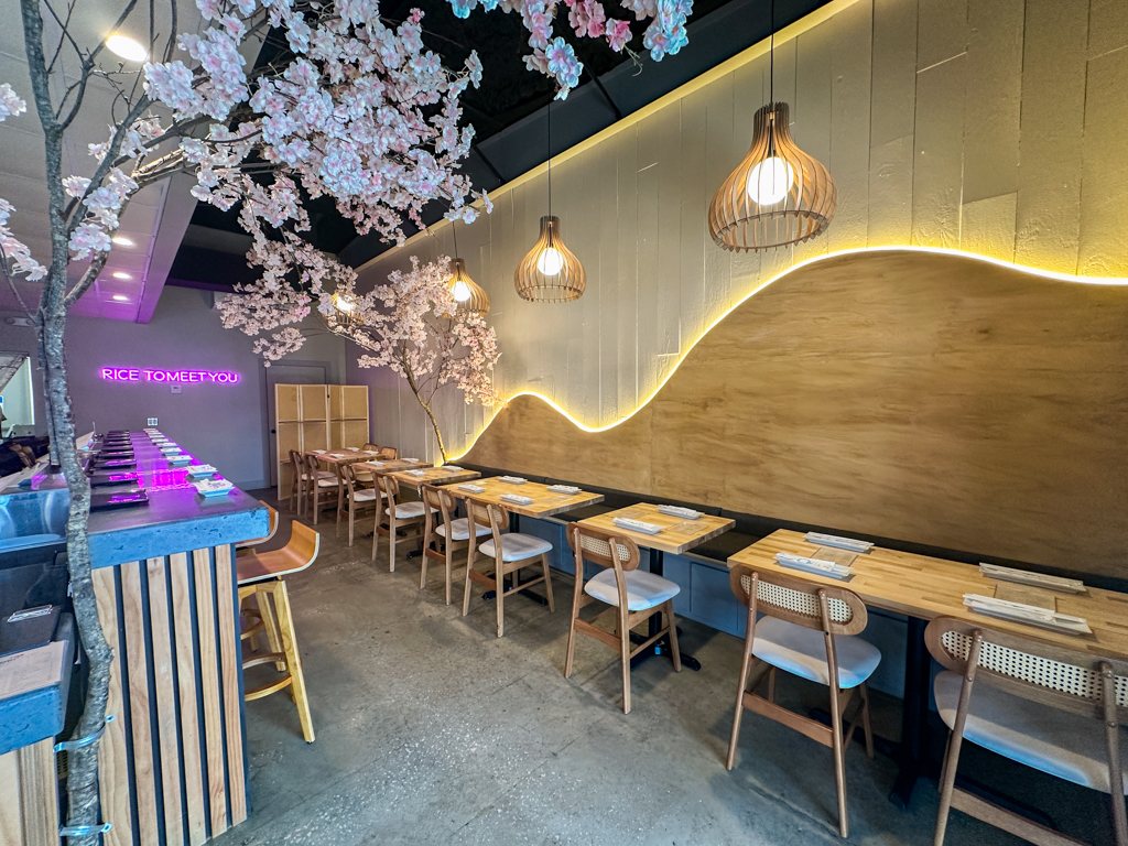 Nori Nori dining room in Tampa with handroll counter, cherry blossom tree and lit wave wall