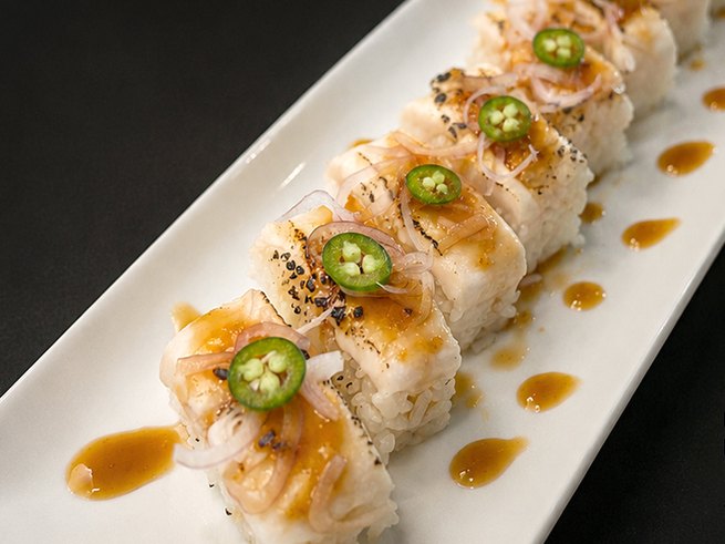 Pressed torched white tuna sushi with miso den sauce and serrano